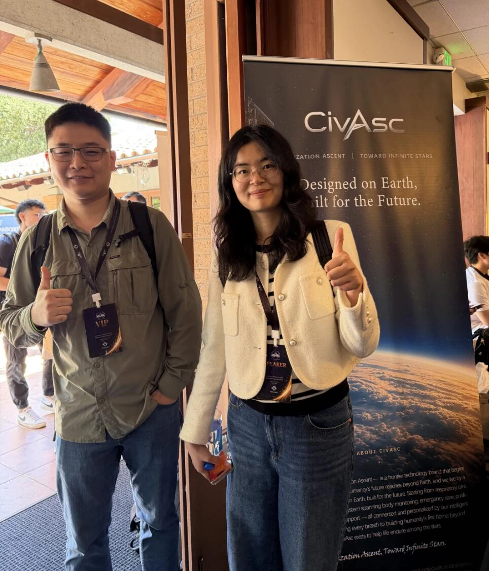 Two guests beside the CivAsc exhibition banner
