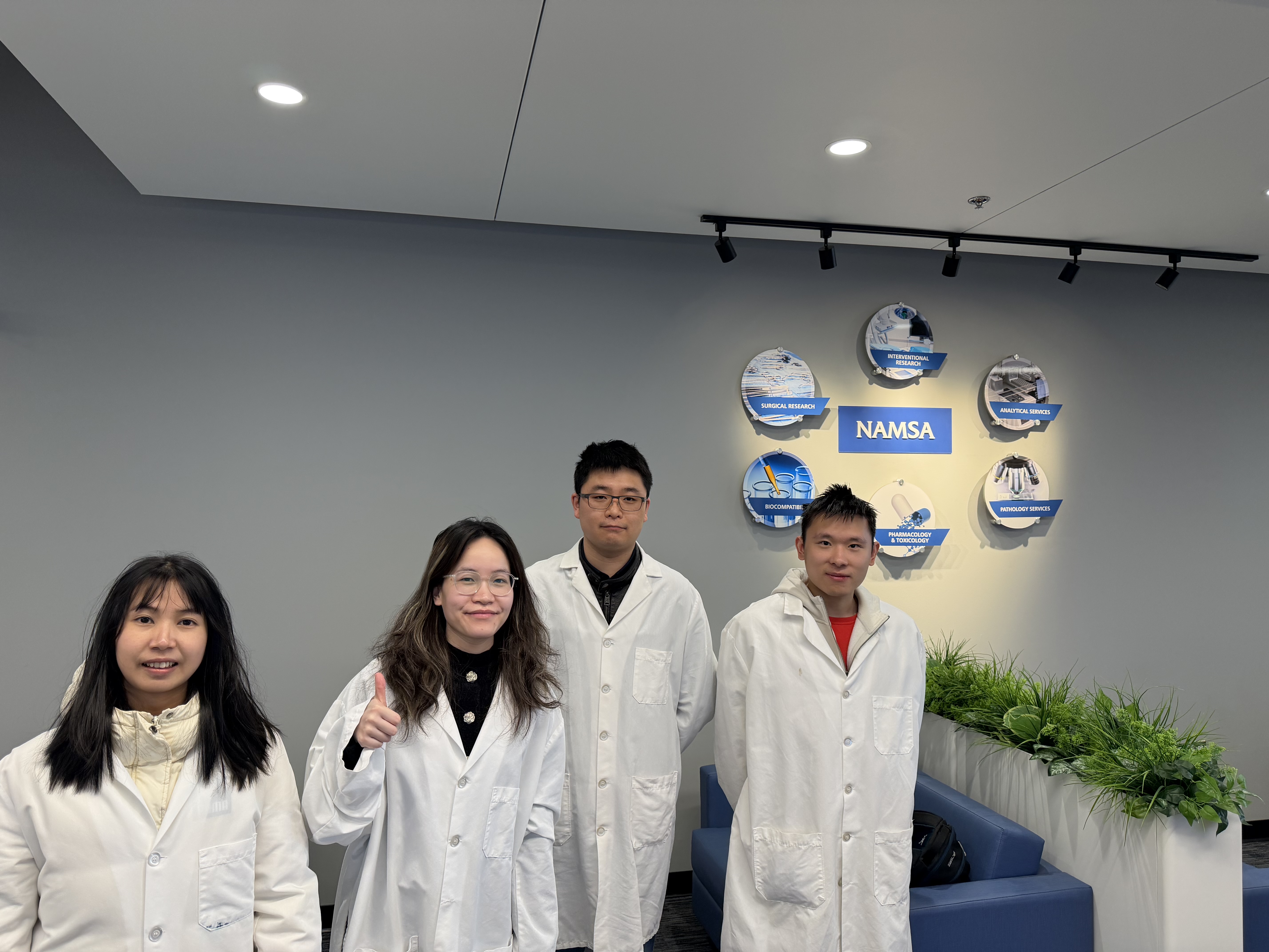 Group photograph in front of the NAMSA sign